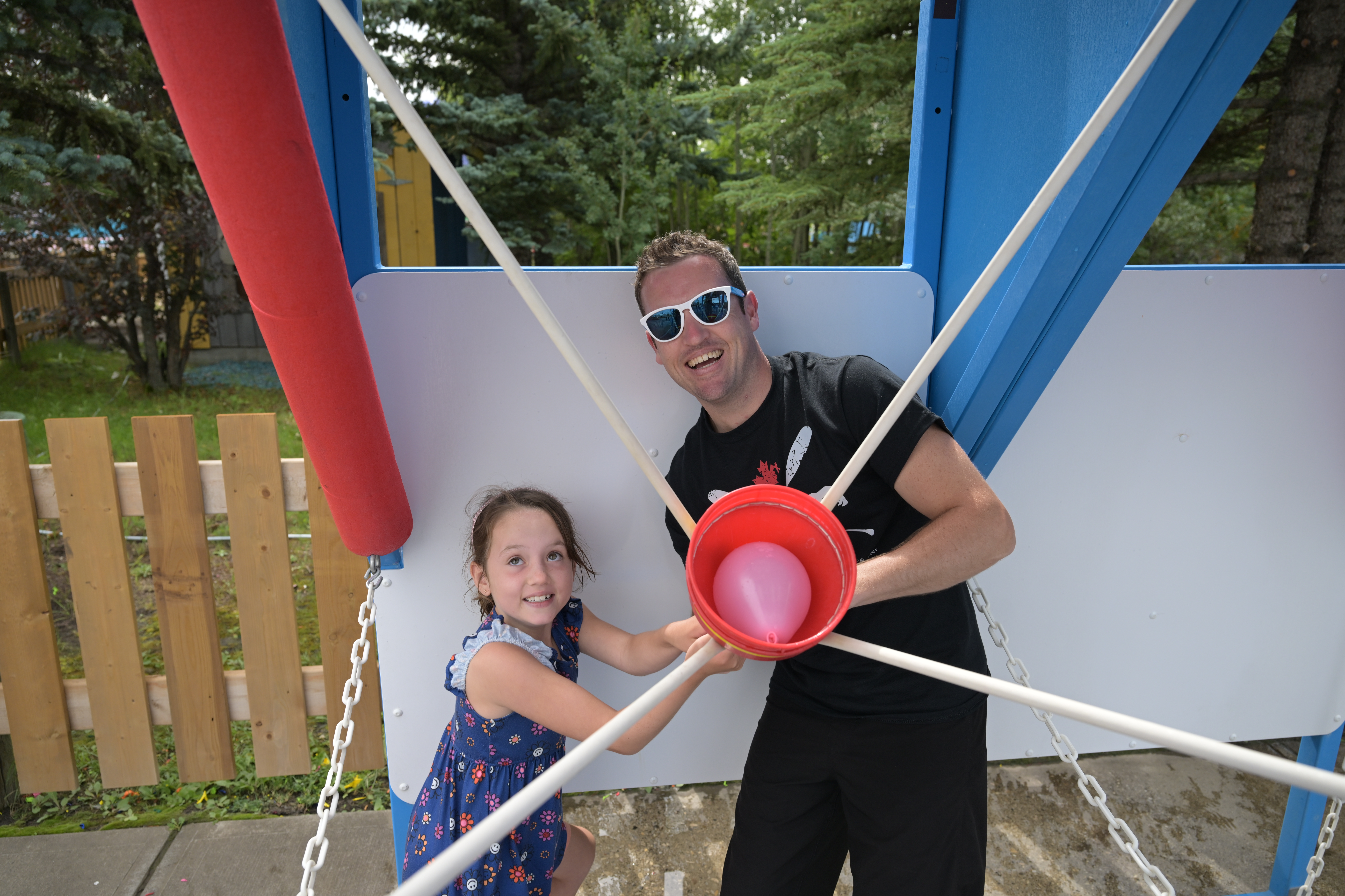 Father and son playing the Water Wars Double Dyno water balloon game