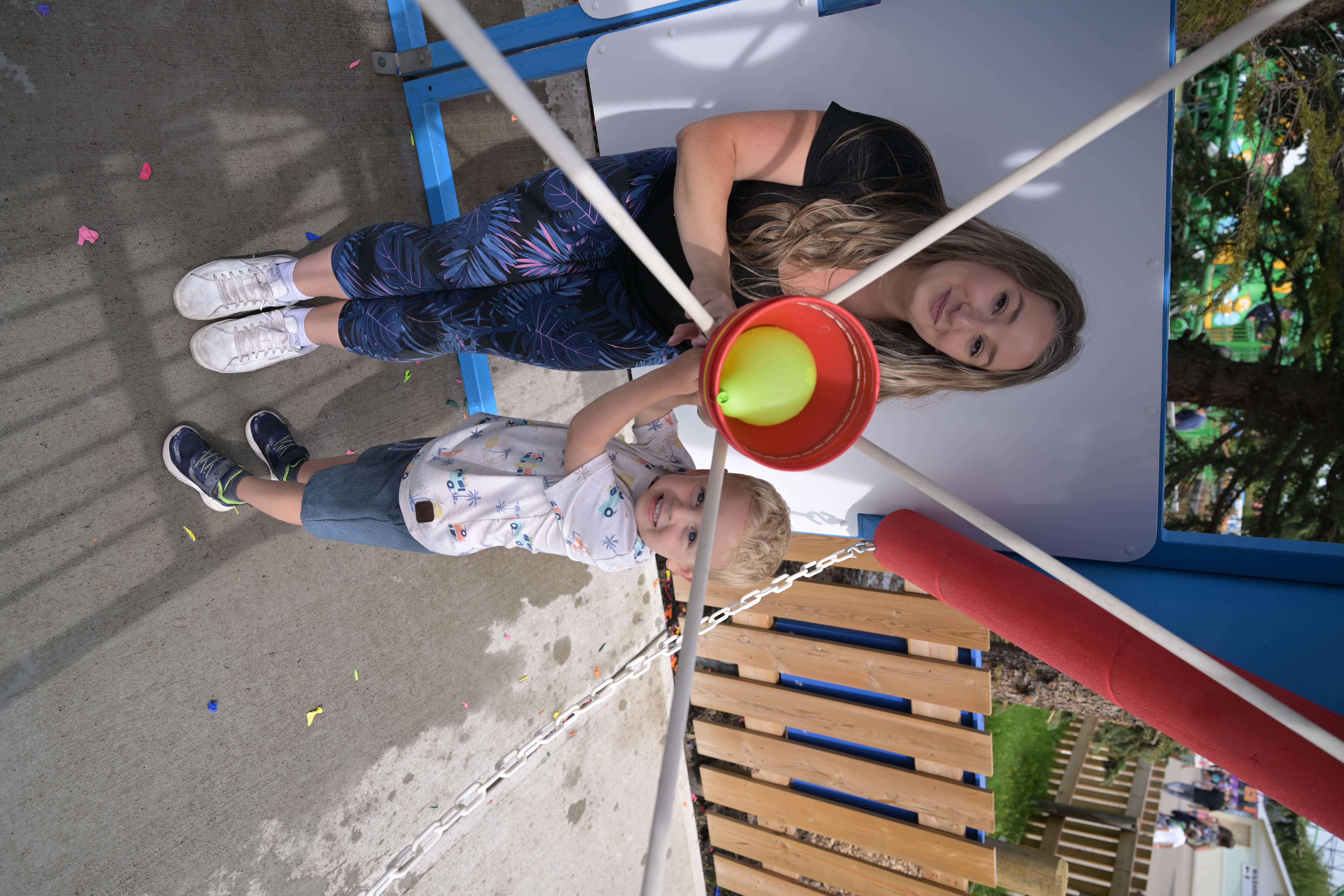 Father and son playing the Water Wars Double Dyno water balloon game